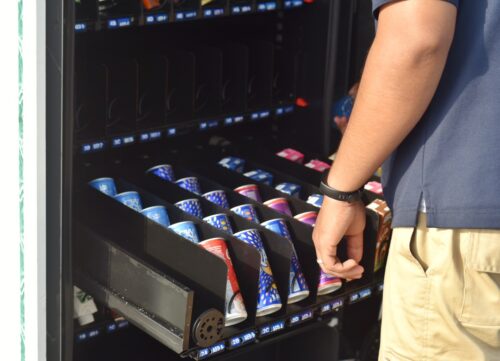 Man restocks drinks in a vending machine
